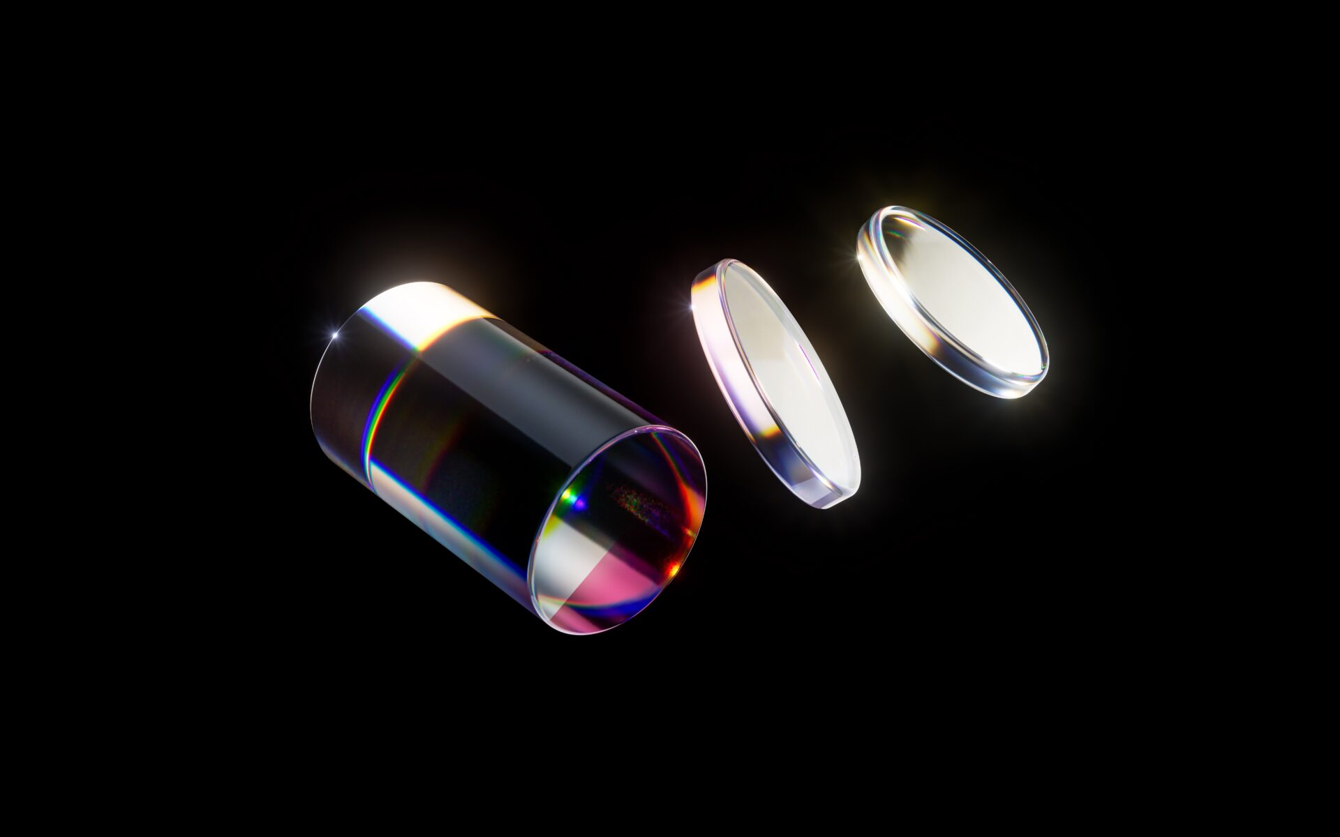 Optical glass cylinder and lenses with colorful reflections on a black background.